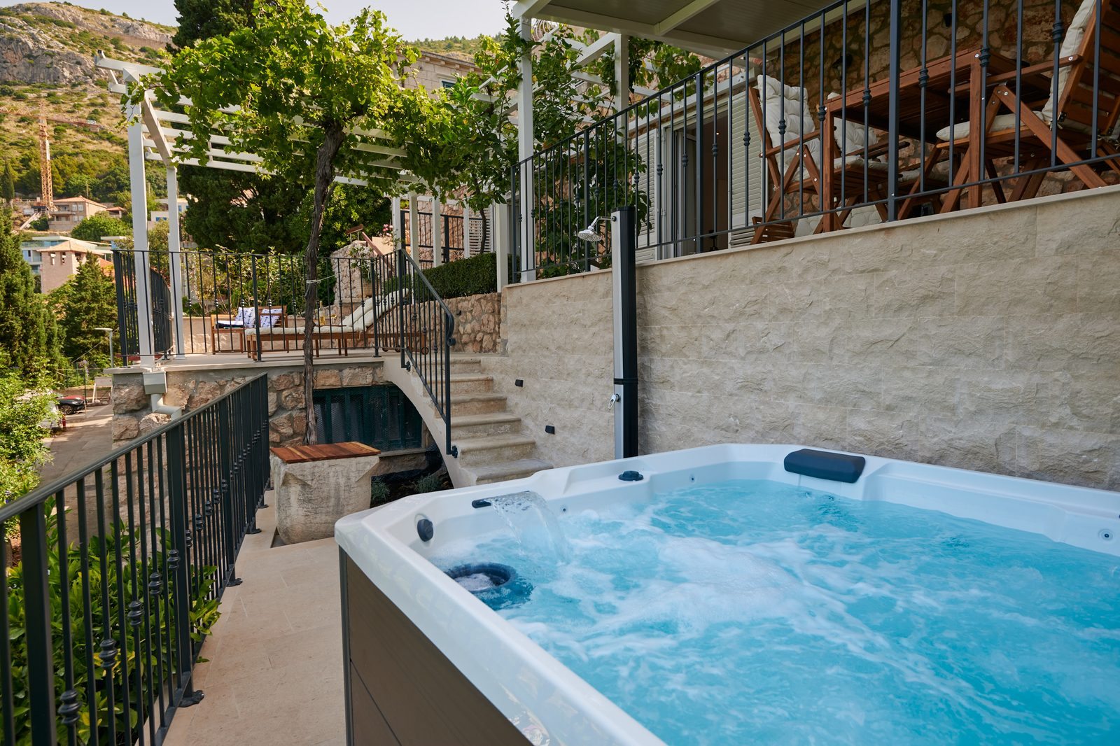 Outdoor hot tub surrounded by Mediterranean plants