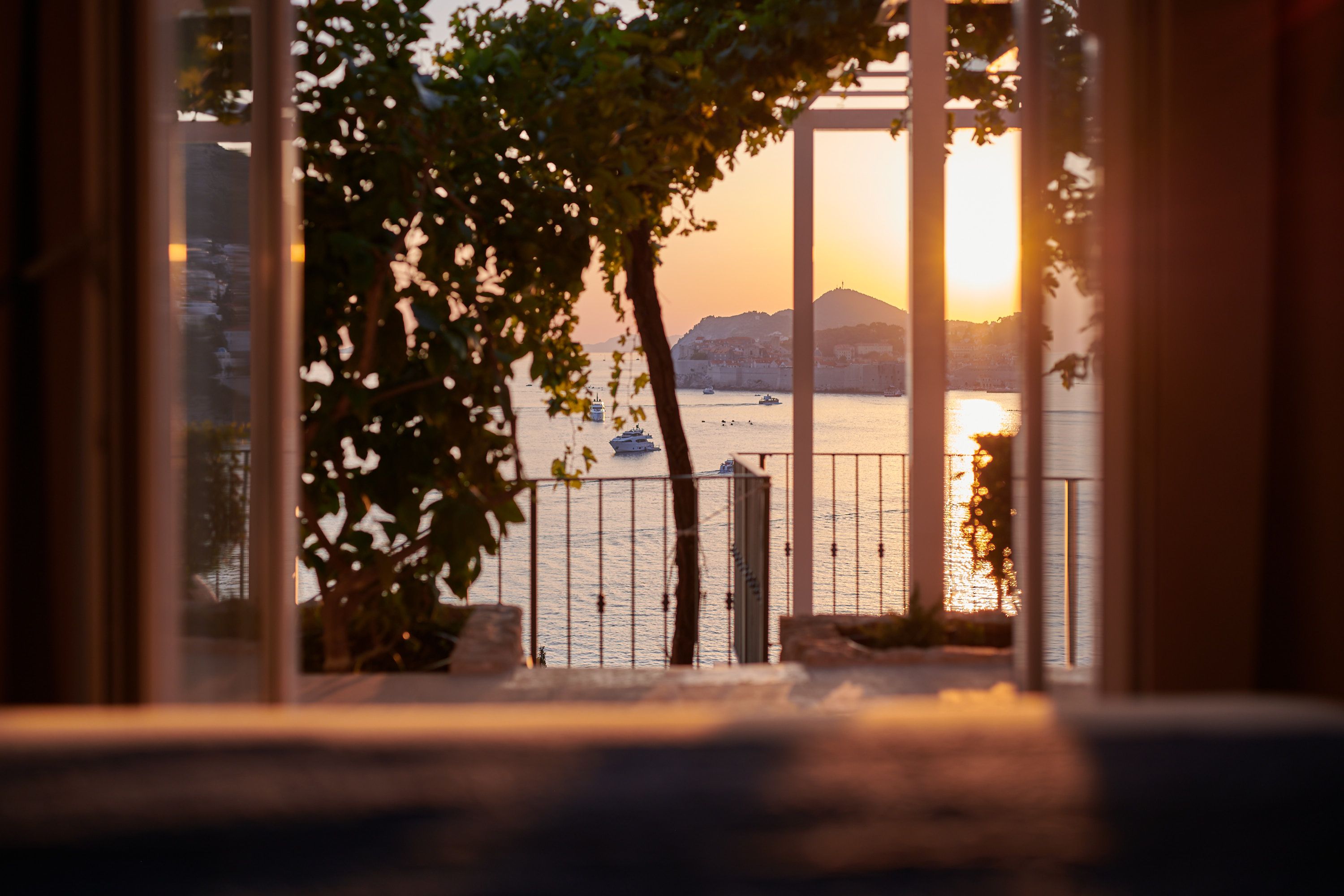 Sea Whisper terrace at sunset with city lights emerging